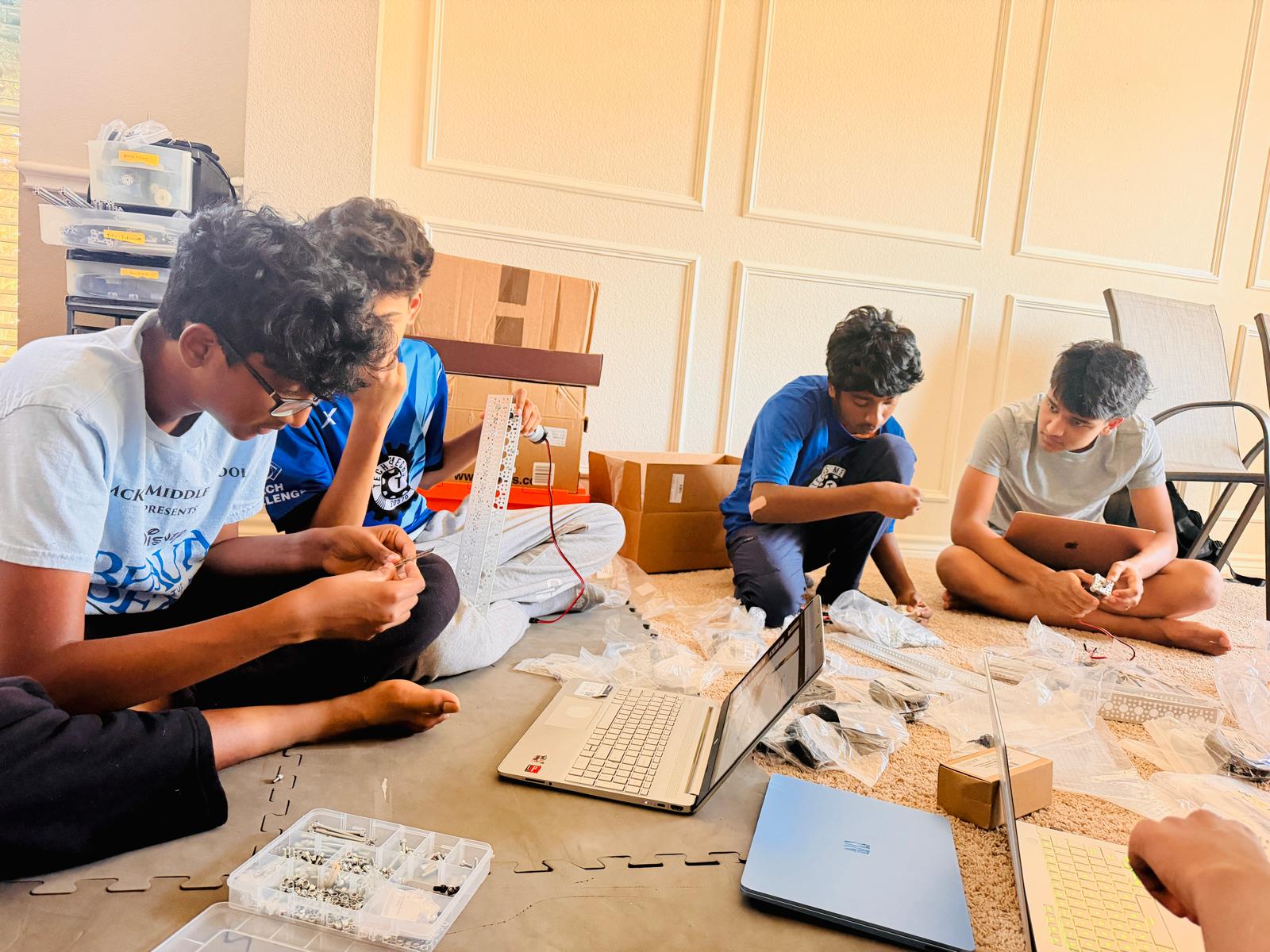 Techs Mechs students building the BioBuzz robot during build session 1